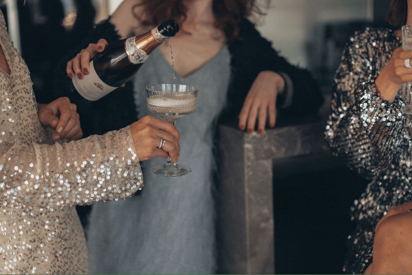 Wedding guests in formalwear toasting with champagne
